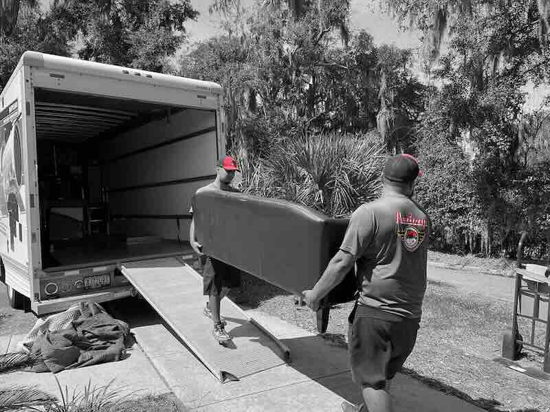 Men loading sofa into moving truck